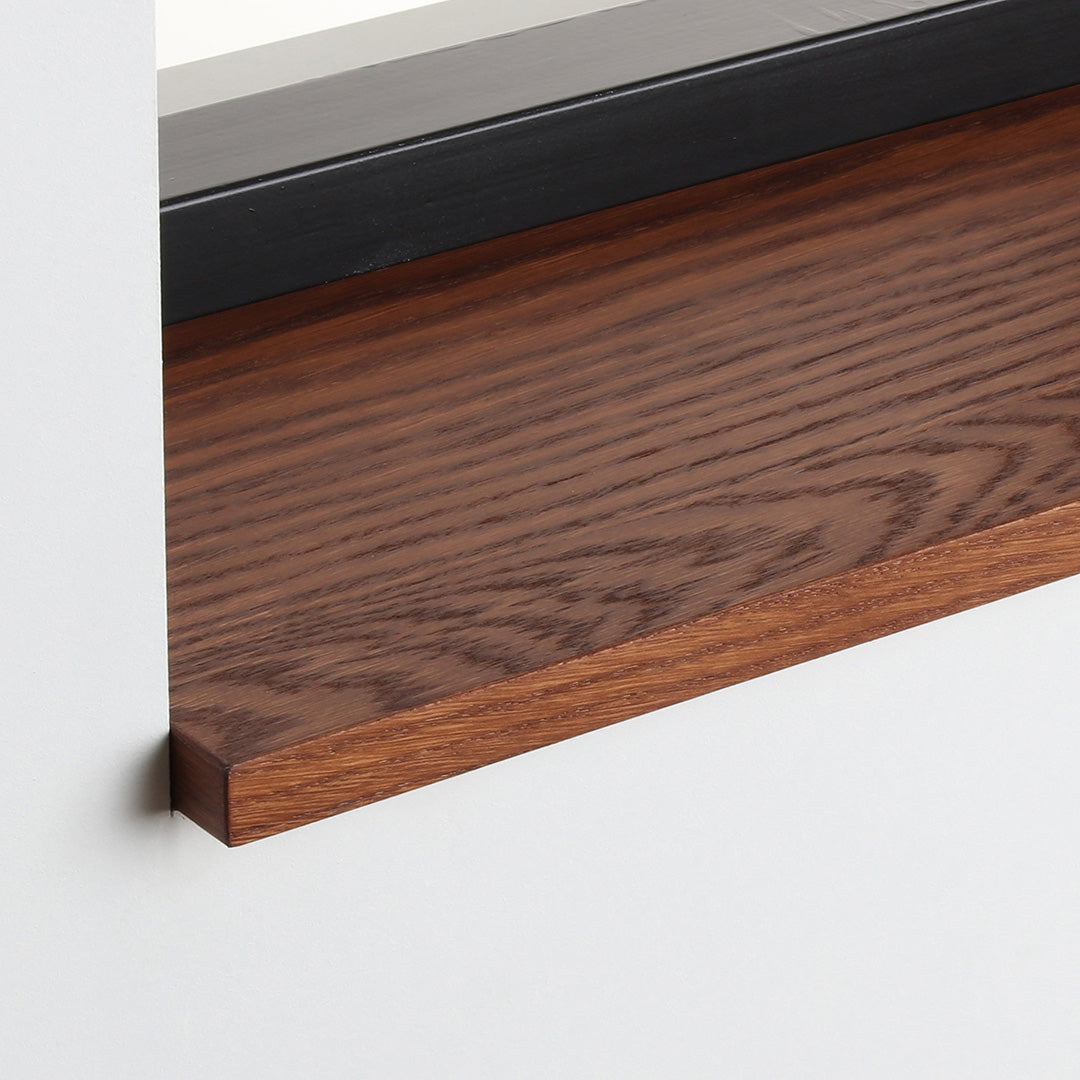 Detail van de eiken gefineerde vensterbank Smoked Oak met matte beits onder het raam.